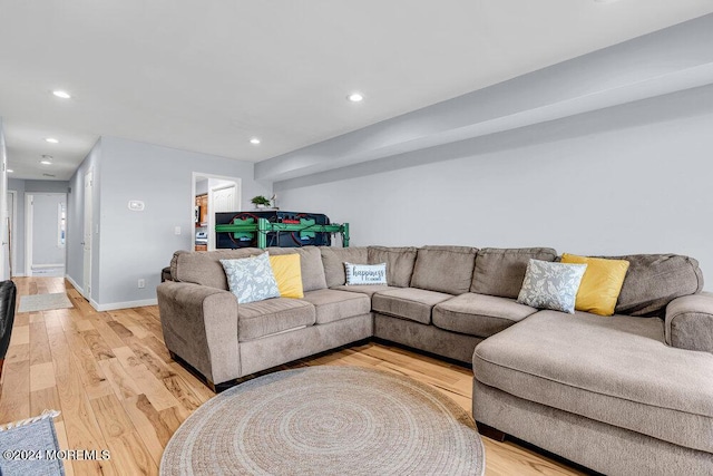 living area with light wood-type flooring, recessed lighting, and baseboards