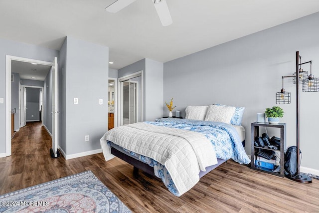 bedroom with baseboards, a ceiling fan, a closet, and wood finished floors