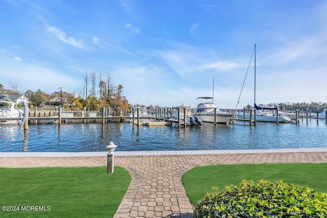 dock area featuring a yard and a water view