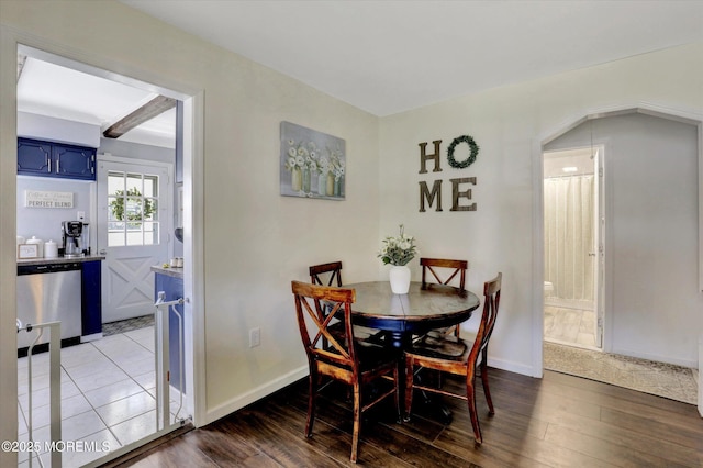 dining space featuring baseboards and wood finished floors