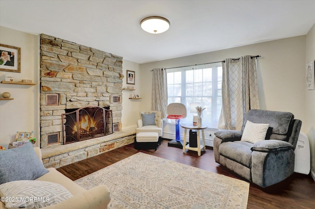 living room featuring dark wood-style floors and a fireplace