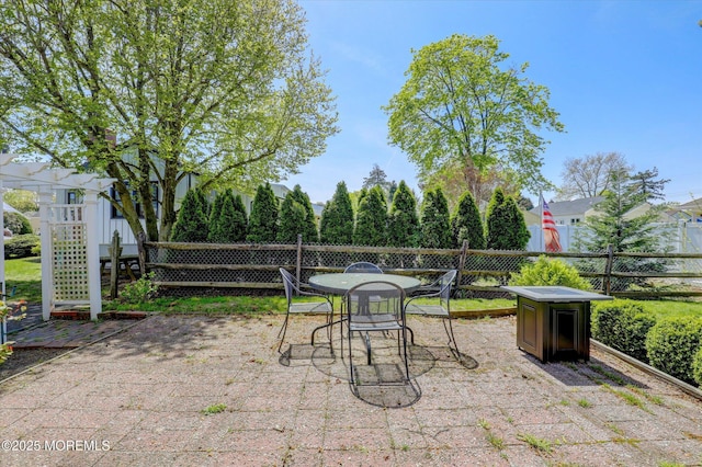 view of patio featuring fence and outdoor dining space