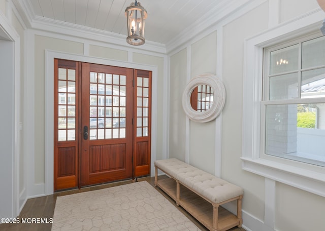 26 Bridge, Bay Head, NJ 08742 - entrance foyer with ornamental molding, baseboards, wood finished floors, a chandelier, and a decorative wall