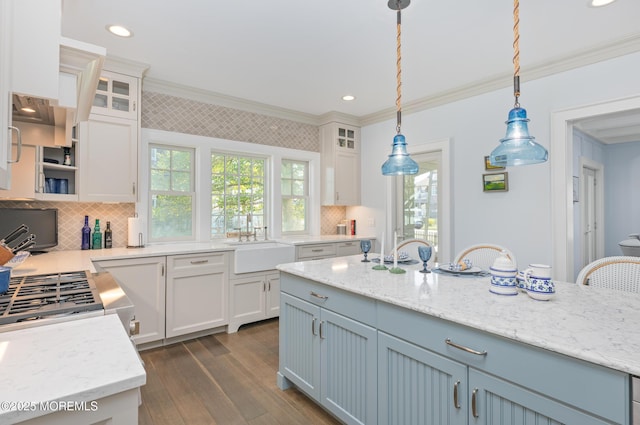 26 Bridge, Bay Head, NJ 08742 - kitchen with a sink, ornamental molding, white cabinets, tasteful backsplash, and dark wood-style flooring