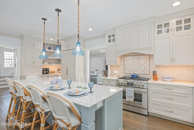 26 Bridge, Bay Head, NJ 08742 - kitchen featuring high end stainless steel range oven, white cabinetry, backsplash, a kitchen island, and a breakfast bar area