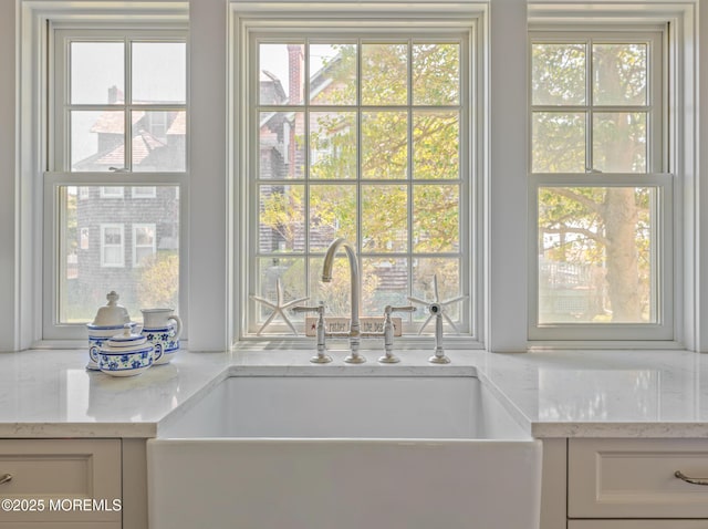 26 Bridge, Bay Head, NJ 08742 - kitchen view of a sink, light stone countertops, and white cabinets