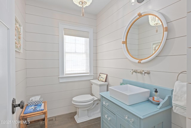 26 Bridge, Bay Head, NJ 08742 - bathroom featuring vanity, toilet, wood finished floors, and wooden walls