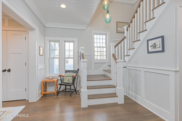 26 Bridge, Bay Head, NJ 08742 - foyer with a decorative wall, crown molding, wood finished floors, stairway, and wainscoting