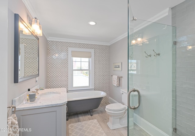 26 Bridge, Bay Head, NJ 08742 - bathroom with crown molding, a stall shower, a freestanding bath, vanity, and toilet