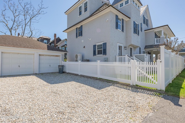 26 Bridge, Bay Head, NJ 08742 - view of side of property with an outdoor structure, a fenced front yard, and gravel driveway
