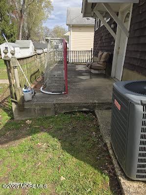 exterior space with a deck and central AC unit