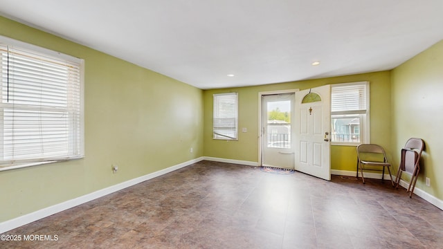 interior space with baseboards and recessed lighting