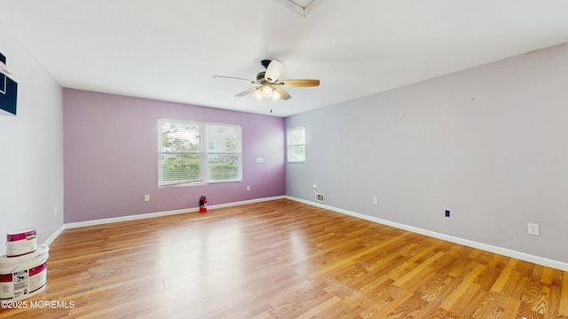 empty room featuring baseboards, ceiling fan, and light wood-style flooring