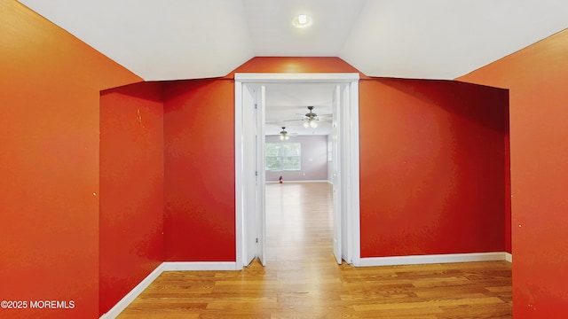 bonus room featuring baseboards, ceiling fan, wood finished floors, and lofted ceiling