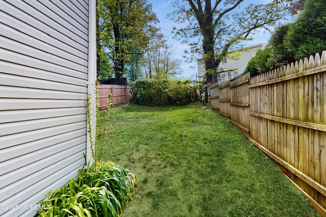 view of yard with a fenced backyard
