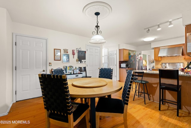 dining space with light wood-style floors