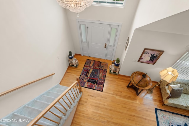 27 Jared Ln, Little Egg Harbor, NJ 08087 - foyer with a chandelier, a high ceiling, wood finished floors, and stairs