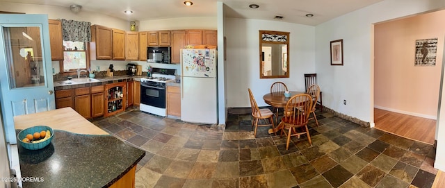 82 Bonita Rd, Waretown, NJ 08758 - kitchen with dark countertops, black microwave, freestanding refrigerator, gas range oven, and stone tile flooring