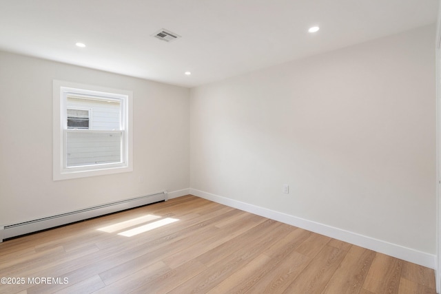 unfurnished room featuring visible vents, baseboards, light wood-style floors, recessed lighting, and a baseboard heating unit