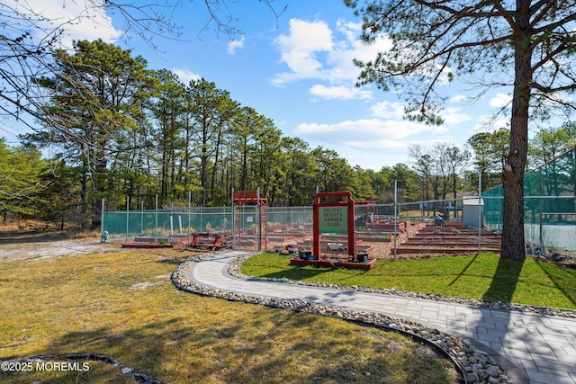 view of playground featuring fence and a yard