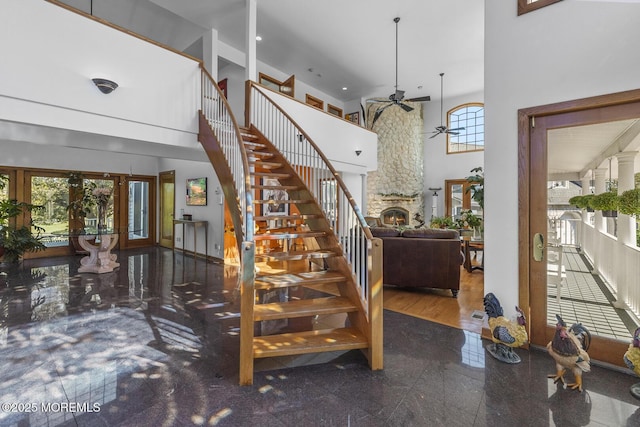 18 Schoolhouse Rd, Cream Ridge, NJ 08514 - stairway with a high ceiling, a fireplace, granite finish floor, french doors, and a ceiling fan