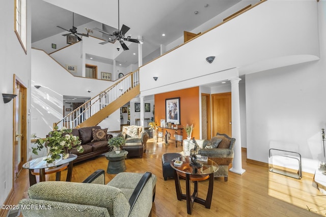 18 Schoolhouse Rd, Cream Ridge, NJ 08514 - living room with decorative columns, a towering ceiling, wood finished floors, ceiling fan, and stairway