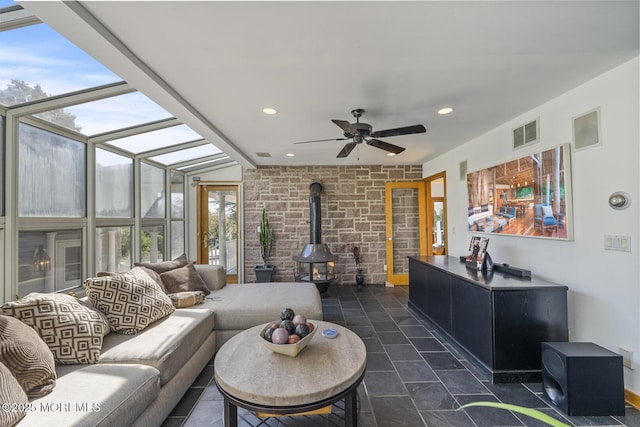 18 Schoolhouse Rd, Cream Ridge, NJ 08514 - living room featuring a healthy amount of sunlight, a ceiling fan, a wood stove, and visible vents
