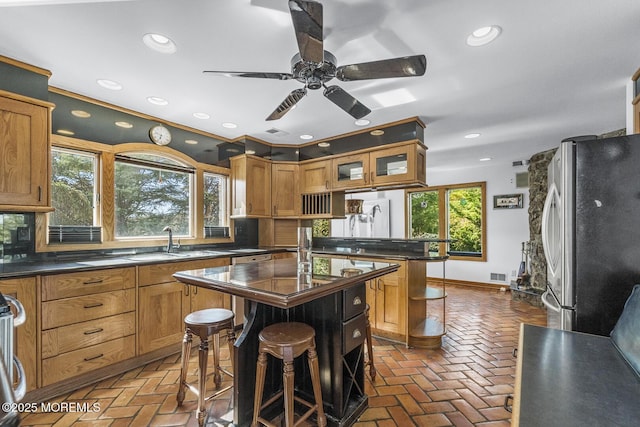18 Schoolhouse Rd, Cream Ridge, NJ 08514 - kitchen featuring dark countertops, ceiling fan, freestanding refrigerator, and brown cabinetry