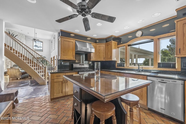 18 Schoolhouse Rd, Cream Ridge, NJ 08514 - kitchen featuring dark countertops, ceiling fan, wall chimney exhaust hood, a sink, and stainless steel appliances