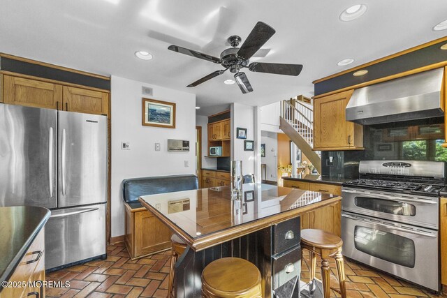 18 Schoolhouse Rd, Cream Ridge, NJ 08514 - kitchen featuring dark countertops, brick floor, wall chimney range hood, and stainless steel appliances