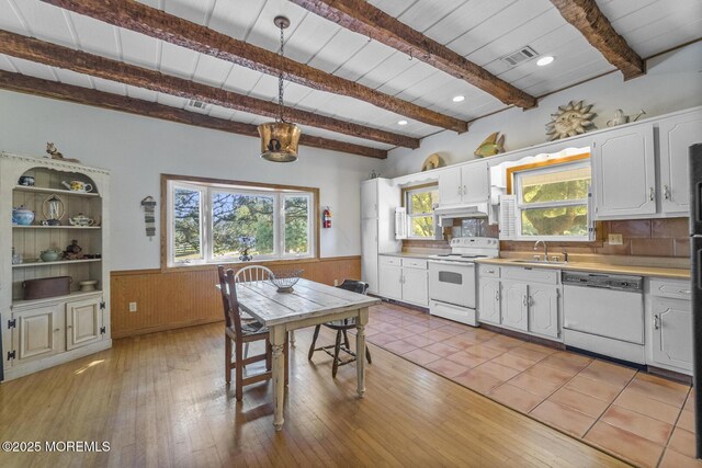 18 Schoolhouse Rd, Cream Ridge, NJ 08514 - kitchen with beam ceiling, a sink, a wainscoted wall, light countertops, and white appliances
