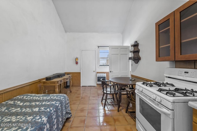 18 Schoolhouse Rd, Cream Ridge, NJ 08514 - bedroom with wooden walls, heating unit, light tile patterned floors, and a wainscoted wall