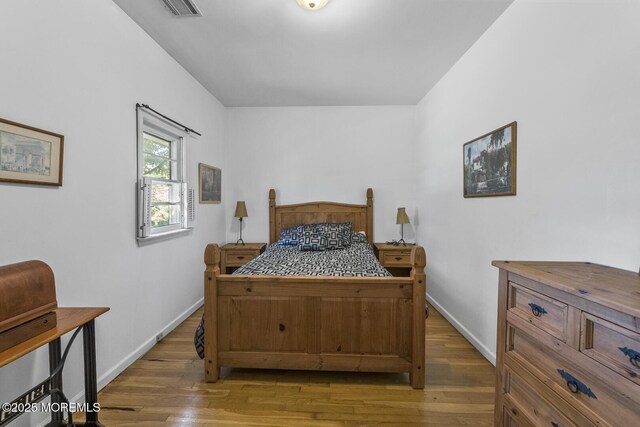 18 Schoolhouse Rd, Cream Ridge, NJ 08514 - bedroom with baseboards, wood finished floors, and visible vents