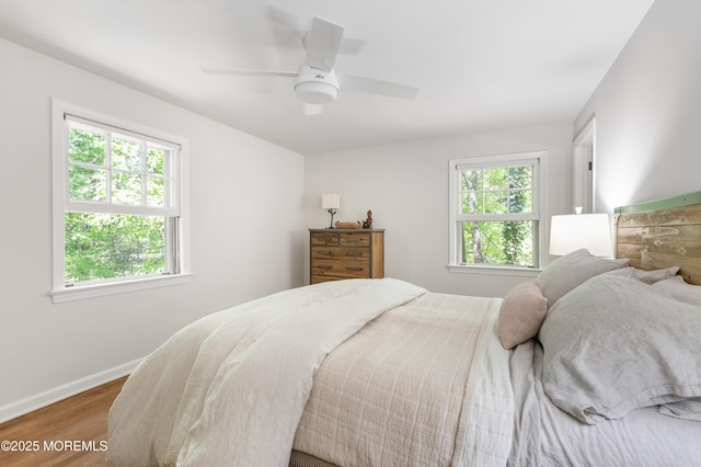 bedroom featuring baseboards, ceiling fan, and wood finished floors