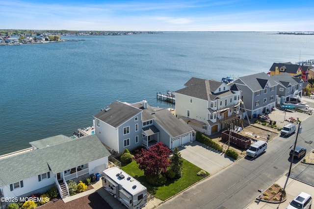 drone / aerial view featuring a water view and a residential view