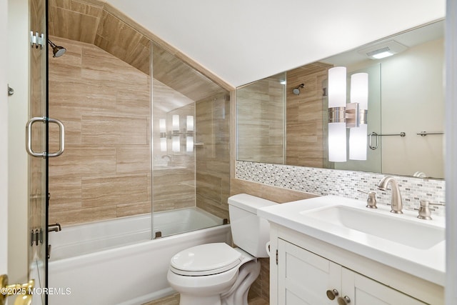 bathroom with decorative backsplash, tile walls, bath / shower combo with glass door, vanity, and toilet