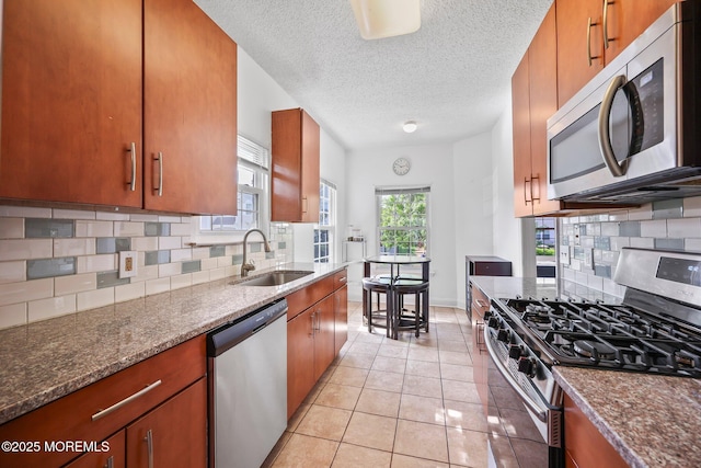 604 Gaitway Ct, Freehold, NJ 07728 - kitchen with dark stone countertops, appliances with stainless steel finishes, a sink, and tasteful backsplash