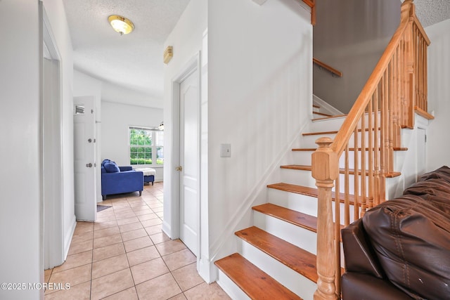 604 Gaitway Ct, Freehold, NJ 07728 - stairway featuring a textured ceiling, tile patterned floors, and baseboards