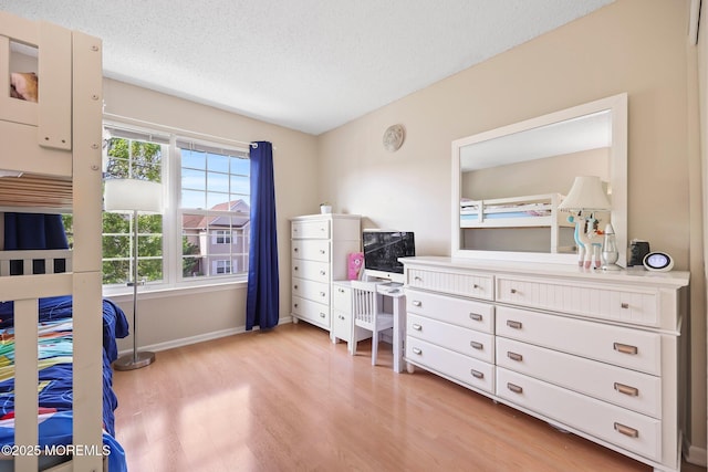 604 Gaitway Ct, Freehold, NJ 07728 - bedroom with baseboards, light wood finished floors, and a textured ceiling