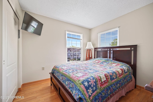 604 Gaitway Ct, Freehold, NJ 07728 - bedroom with baseboards, a textured ceiling, and wood finished floors