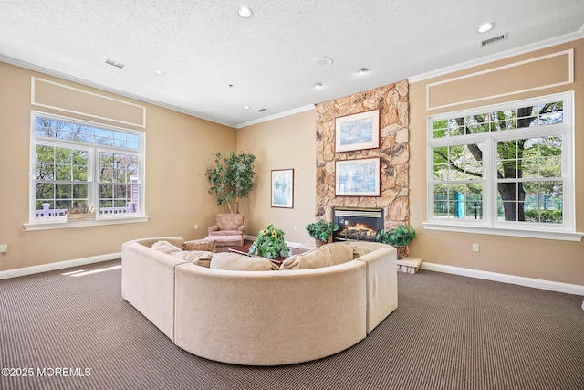 604 Gaitway Ct, Freehold, NJ 07728 - living room with crown molding, visible vents, baseboards, a stone fireplace, and carpet flooring