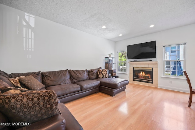 604 Gaitway Ct, Freehold, NJ 07728 - living room with recessed lighting, a textured ceiling, wood finished floors, and a fireplace
