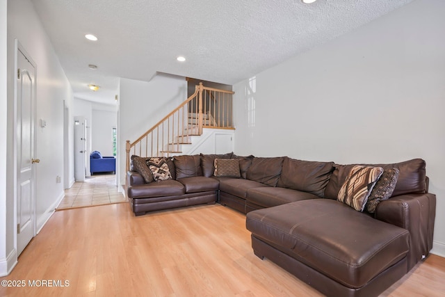 604 Gaitway Ct, Freehold, NJ 07728 - living area with stairs, baseboards, recessed lighting, a textured ceiling, and light wood-style flooring