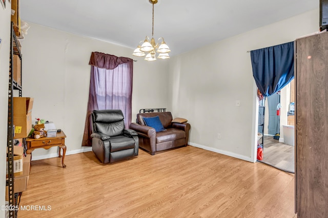 24 Monmouth Ave, Freehold, NJ 07728 - living area featuring light wood-style floors, baseboards, and a chandelier