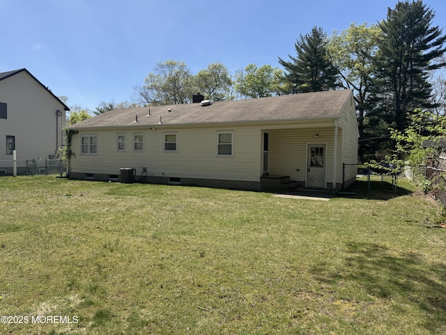 back of property with a lawn, crawl space, fence, and cooling unit