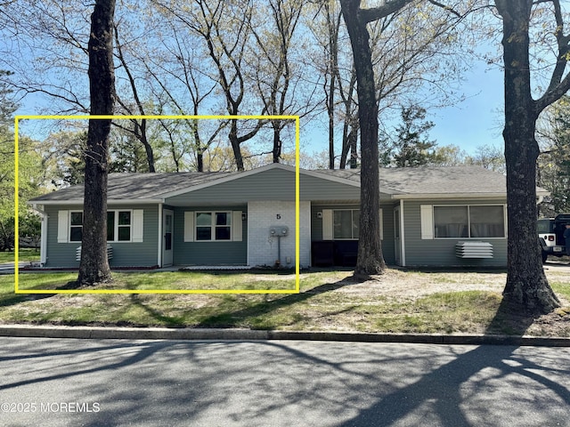 view of front of property with brick siding and a front yard