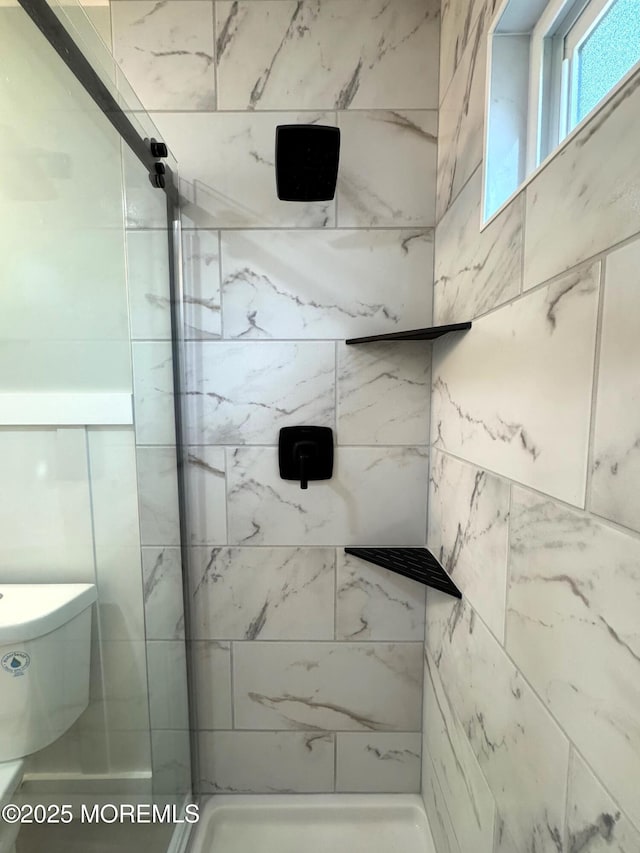 full bathroom featuring a stall shower and toilet