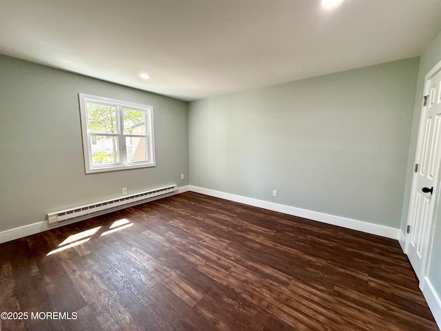spare room with dark wood-type flooring, recessed lighting, baseboards, and baseboard heating