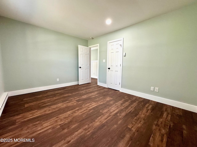 interior space featuring baseboards, recessed lighting, and dark wood-type flooring