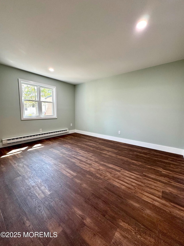 unfurnished room with recessed lighting, baseboards, baseboard heating, and dark wood-style flooring